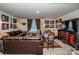 Finished basement recreation room with leather sectional sofa, large TV, and entertainment center at 127 Doncaster Dr, Mooresville, NC 28115