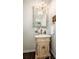 Elegant powder room with a unique seashell mirror and marble vanity at 127 Doncaster Dr, Mooresville, NC 28115