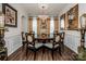 Elegant dining room with a large table, ornate mirrors, and hardwood floors at 127 Doncaster Dr, Mooresville, NC 28115