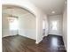 Bright entryway with hardwood floors, high ceilings, and an arched passage to the dining room at 127 Doncaster Dr, Mooresville, NC 28115