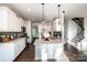 Modern kitchen with island, stainless steel appliances, and white cabinetry at 127 Doncaster Dr, Mooresville, NC 28115