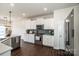 Well-equipped kitchen featuring white cabinets, stainless steel appliances, and quartz countertops at 127 Doncaster Dr, Mooresville, NC 28115