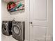 Laundry room with washer, dryer, and overhead shelving at 127 Doncaster Dr, Mooresville, NC 28115