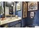 Stylish bathroom with dark blue walls, gold accents, and a modern vanity at 1419 Jules Ct, Charlotte, NC 28226