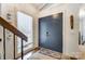 Bright entryway with a dark blue double door and a view of the staircase at 1419 Jules Ct, Charlotte, NC 28226