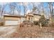 House exterior featuring a yellow wood exterior, stone accents, and a two-car garage at 1419 Jules Ct, Charlotte, NC 28226