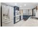 Modern kitchen with white appliances and dark blue cabinetry at 1419 Jules Ct, Charlotte, NC 28226