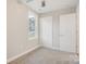 Well-lit bedroom featuring gray carpet, double doors to closet, and a window at 1455 Southwest Blvd, Newton, NC 28658