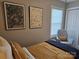 Bright bedroom with mustard yellow bedding, gray chair, and framed art at 1455 Southwest Blvd, Newton, NC 28658