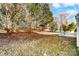 Landscaped backyard with mature trees and lawn at 15011 Edindale Dr, Charlotte, NC 28277