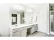 Double vanity bathroom with gray cabinets and a large mirror at 15011 Edindale Dr, Charlotte, NC 28277