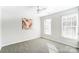 Well-lit bedroom featuring two windows and wall art at 15011 Edindale Dr, Charlotte, NC 28277