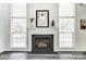 Living room fireplace with a modern mantel and built-in shelving at 15011 Edindale Dr, Charlotte, NC 28277