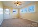 Sunny bedroom with carpeted floor, ceiling fan, and ample natural light from windows at 1715 Emmanuel Church Rd, Conover, NC 28613