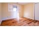 A cozy bedroom features wood floors, one window and light yellow walls at 1715 Emmanuel Church Rd, Conover, NC 28613