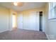 Bedroom featuring carpeted floor, closet, and a window with a view at 1715 Emmanuel Church Rd, Conover, NC 28613