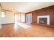 Bright living room featuring hardwood floors, brick fireplace, and access to outdoor area at 1715 Emmanuel Church Rd, Conover, NC 28613