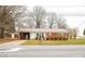 A charming red brick house with a metal roof and a well-manicured lawn at 1715 Emmanuel Church Rd, Conover, NC 28613