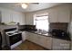 Kitchen with white cabinets, double sink, and microwave at 1750 Oak Valley Dr, Gastonia, NC 28054