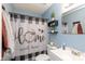 Bathroom with black and white checkered shower curtain and white vanity at 1825 Bloomsbury Dr, Rock Hill, SC 29730