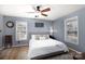 Cozy bedroom featuring hardwood floors, ceiling fan, and natural light from dual windows at 1825 Bloomsbury Dr, Rock Hill, SC 29730