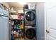 Efficient laundry room with stacked washer and dryer and storage shelves at 1825 Bloomsbury Dr, Rock Hill, SC 29730