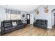 Relaxing living room featuring hardwood floors and two leather sofas at 1825 Bloomsbury Dr, Rock Hill, SC 29730