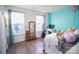 Charming bedroom with light teal accent wall and hardwood floors at 1866 Baylor Dr, Rock Hill, SC 29732