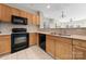 This kitchen features oak cabinets, modern appliances, stainless steel sink, and a tile floor at 18736 Nautical Dr # 201, Cornelius, NC 28031