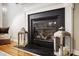 Modern gas fireplace with dark slate surround and decorative lanterns at 2012 Orby Ave, Indian Trail, NC 28079