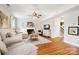 Living room with hardwood floors, fireplace, and neutral colored sectional sofa at 2012 Orby Ave, Indian Trail, NC 28079