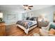 Main bedroom with wood floors, ceiling fan, and calming decor at 2012 Orby Ave, Indian Trail, NC 28079