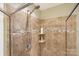 Shower with tiled walls and built-in shelf at 2012 Orby Ave, Indian Trail, NC 28079