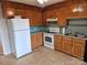 Galley style kitchen with wood cabinets and white appliances at 240 Pointe Cir # 240, Rock Hill, SC 29732