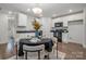 Modern kitchen with white cabinets, black countertops, and dining area at 275 Broad Sw Dr, Concord, NC 28025