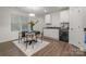 Modern kitchen with white cabinets and a round dining table at 275 Broad Sw Dr, Concord, NC 28025