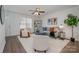 Bright living room with gray sofa and comfy armchairs at 275 Broad Sw Dr, Concord, NC 28025