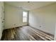 Simple bedroom with large window and wood-look flooring at 2906 Lathan Rd, Monroe, NC 28112