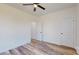 Bedroom with wood floors, ceiling fan, white trim and doors and neutral paint at 2906 Lathan Rd, Monroe, NC 28112