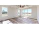 Large bedroom with tray ceiling, ceiling fan, and expansive windows bringing in natural light at 2906 Lathan Rd, Monroe, NC 28112