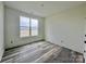 Bright bedroom with large window and wood-look floors at 2906 Lathan Rd, Monroe, NC 28112