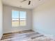 Bright bedroom with wood floors, a ceiling fan, a large window, and neutral paint at 2906 Lathan Rd, Monroe, NC 28112