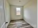 Simple bedroom with wood-look floors and a window offering natural light at 2906 Lathan Rd, Monroe, NC 28112