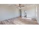 Expansive bedroom with wood-look flooring, coffered ceiling with fan, and a view to the bathroom at 2906 Lathan Rd, Monroe, NC 28112