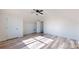 Spacious bedroom with vaulted ceiling, ceiling fan, two doors, and wood-look flooring at 2906 Lathan Rd, Monroe, NC 28112