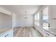 Bright dining area featuring wood floors, a modern chandelier, and large windows offering natural light at 2906 Lathan Rd, Monroe, NC 28112