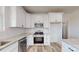 Modern kitchen with stainless steel appliances, white cabinets, granite countertops, and wood flooring at 2906 Lathan Rd, Monroe, NC 28112