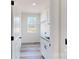 Bright laundry room featuring modern cabinets, a sink, and a window overlooking the backyard at 2906 Lathan Rd, Monroe, NC 28112