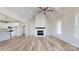 Spacious living room with a fireplace, wood floors, and open concept design at 2906 Lathan Rd, Monroe, NC 28112