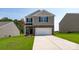 Two-story house with stone accents and a two-car garage at 3016 Ora Smith Rd, Lincolnton, NC 28092